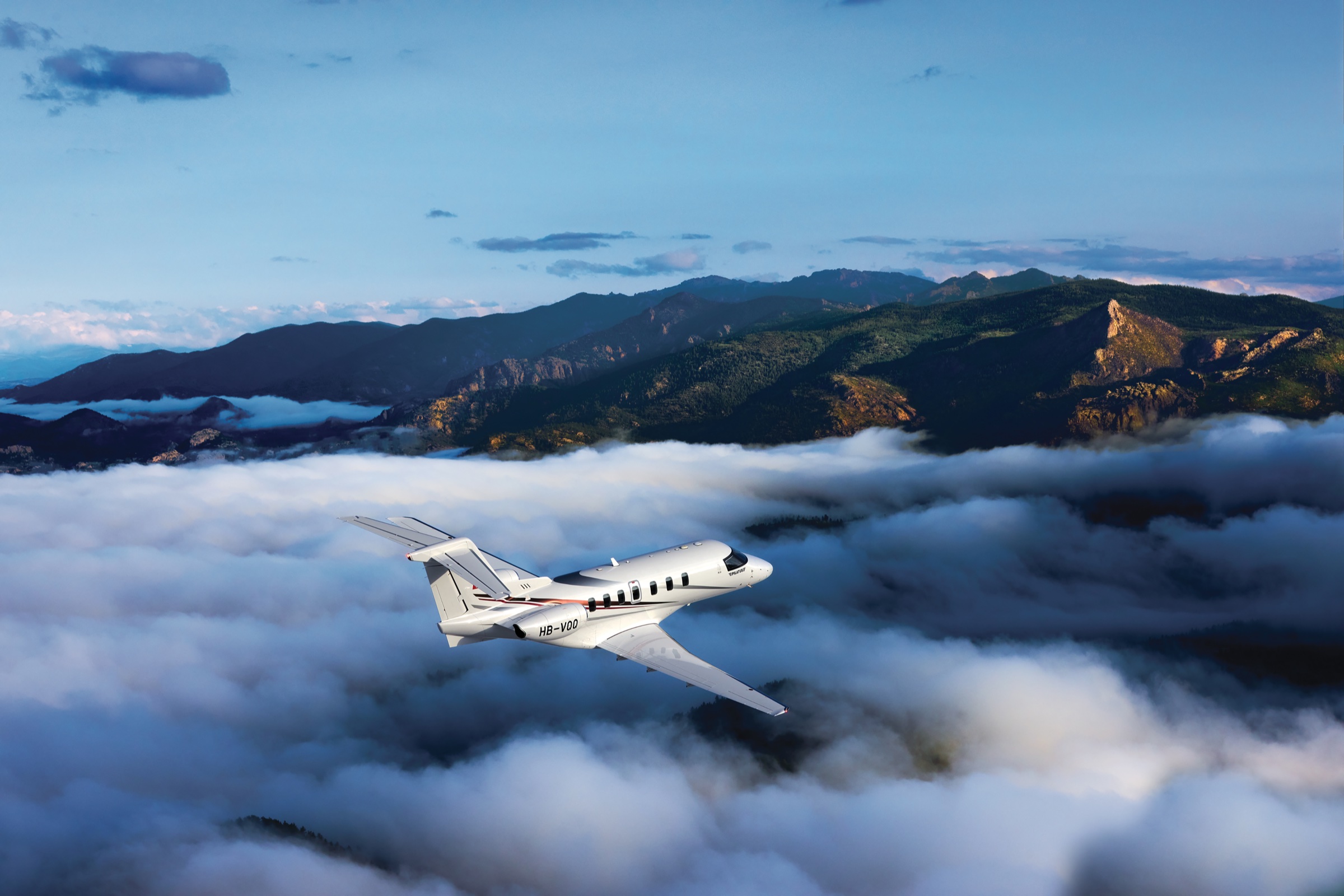 Pilatus PC-24 in flight above snow-covered mountains